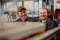 The image shows two employees in a manufacturing site.