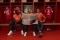 The image shows Dayot Upamecano, Manuel Neuer, and Joshua Kimmich in the FC Bayern locker room, reading a newspaper.