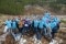The image shows a group of Viessmann Climate Solutions employees in an open field where 1,200 trees are being planted.