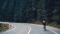 The image shows a cyclist on a mountain road